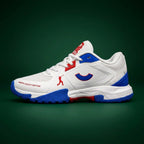 Side profile of the Tenxu All-Rounder cricket rubber shoes in white, blue, and red, featuring a durable TPU upper, patterned rubber outsole, and North Legacy Edition branding.