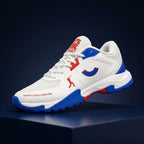 Angled front profile of the Tenxu All-Rounder cricket rubber shoes in white, blue, and red, featuring a breathable mesh toe, red branding accents, and North Legacy Edition text on the mudguard.