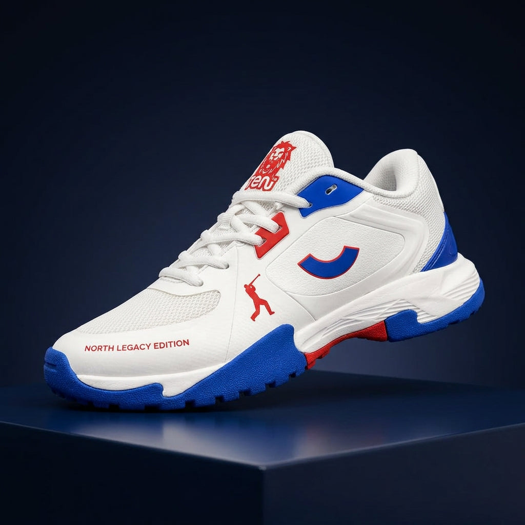 Angled front profile of the Tenxu All-Rounder cricket rubber shoes in white, blue, and red, featuring a breathable mesh toe, red branding accents, and North Legacy Edition text on the mudguard.