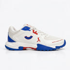 Side profile of the Tenxu All-Rounder cricket rubber shoes in white, blue, and red, featuring a durable TPU upper, patterned rubber outsole, and North Legacy Edition branding.